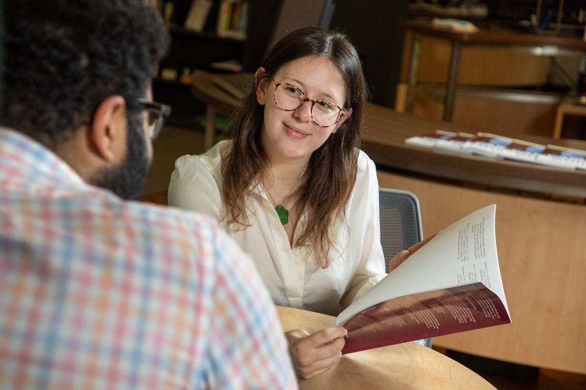 image of woman holding booklet